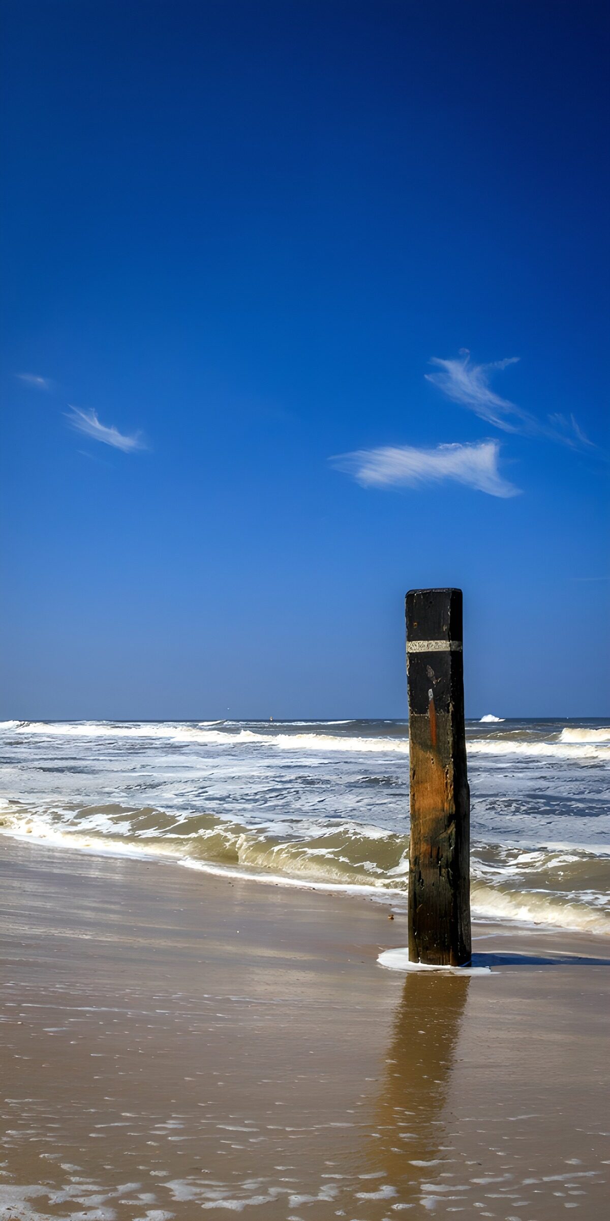 TPDE16993: Ruhe am Strand mit Pfahl im Wasser
