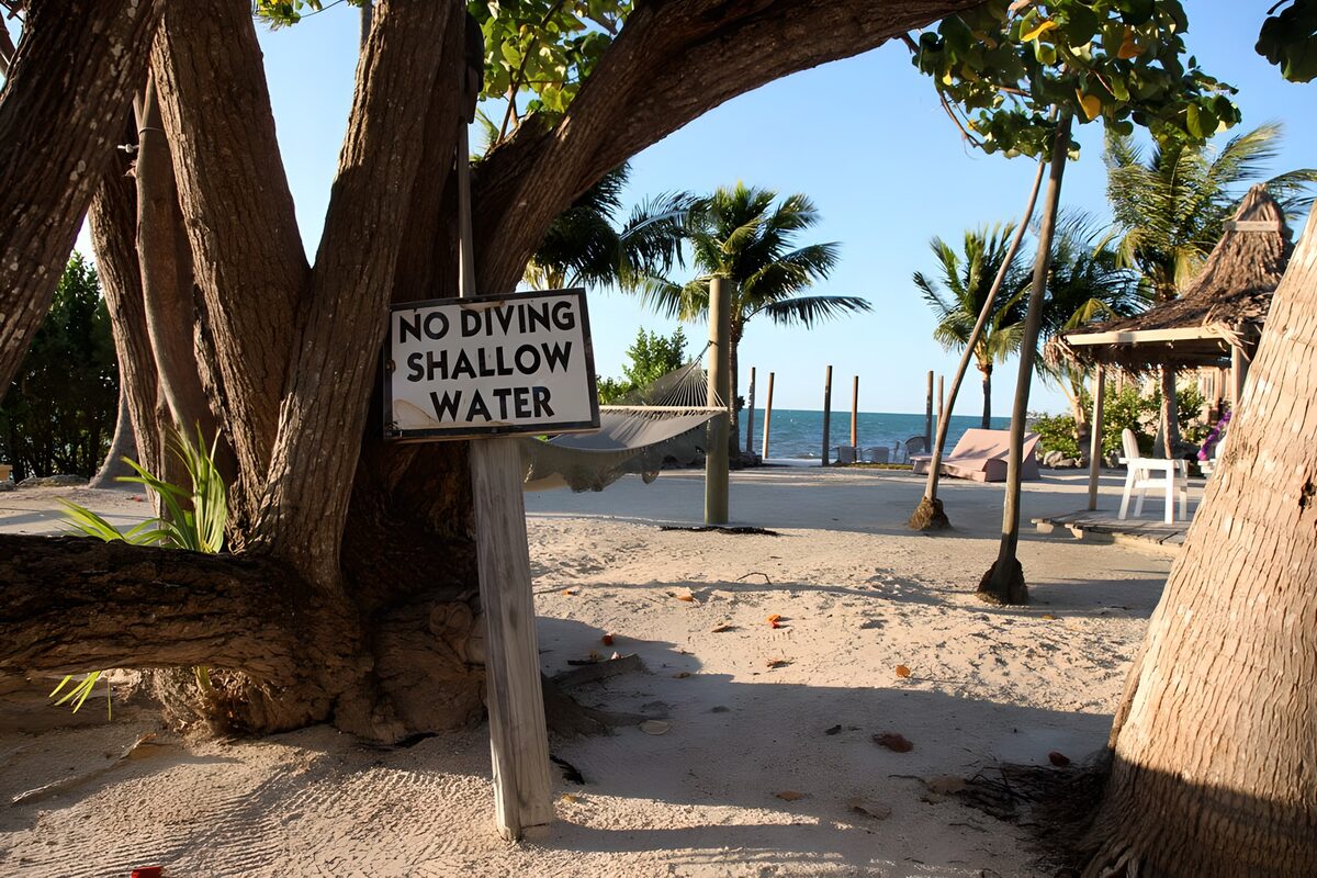 TPDE32563: karibischer Strand mit Schild 'no diving-shallow water'